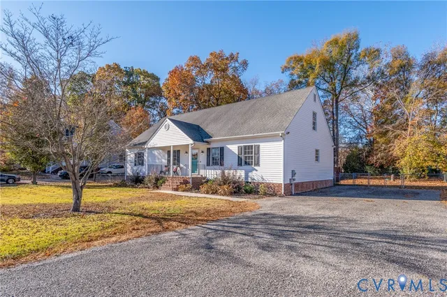 a front view of house with yard and trees around