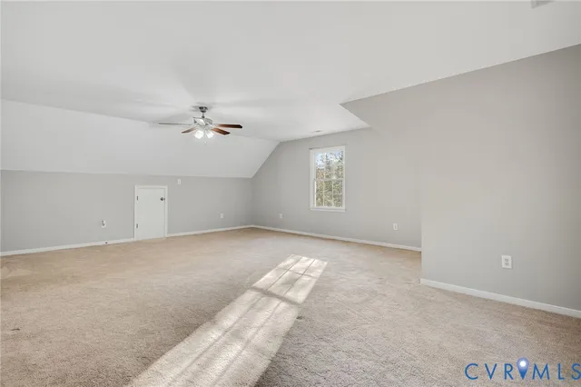 a view of a livingroom with a ceiling fan and window
