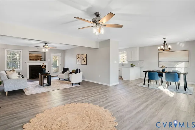 a living room with fireplace furniture and a wooden floor