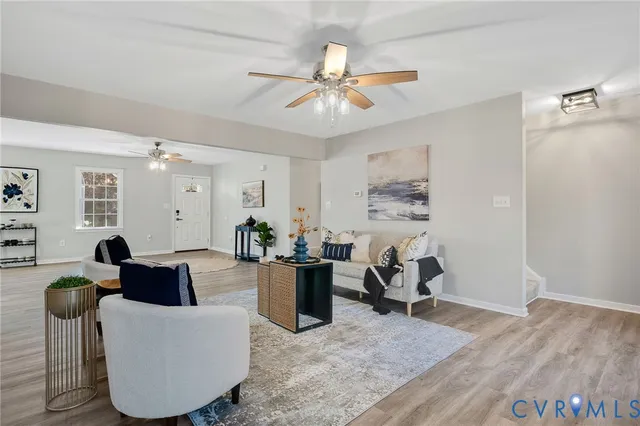 a living room with furniture and wooden floor