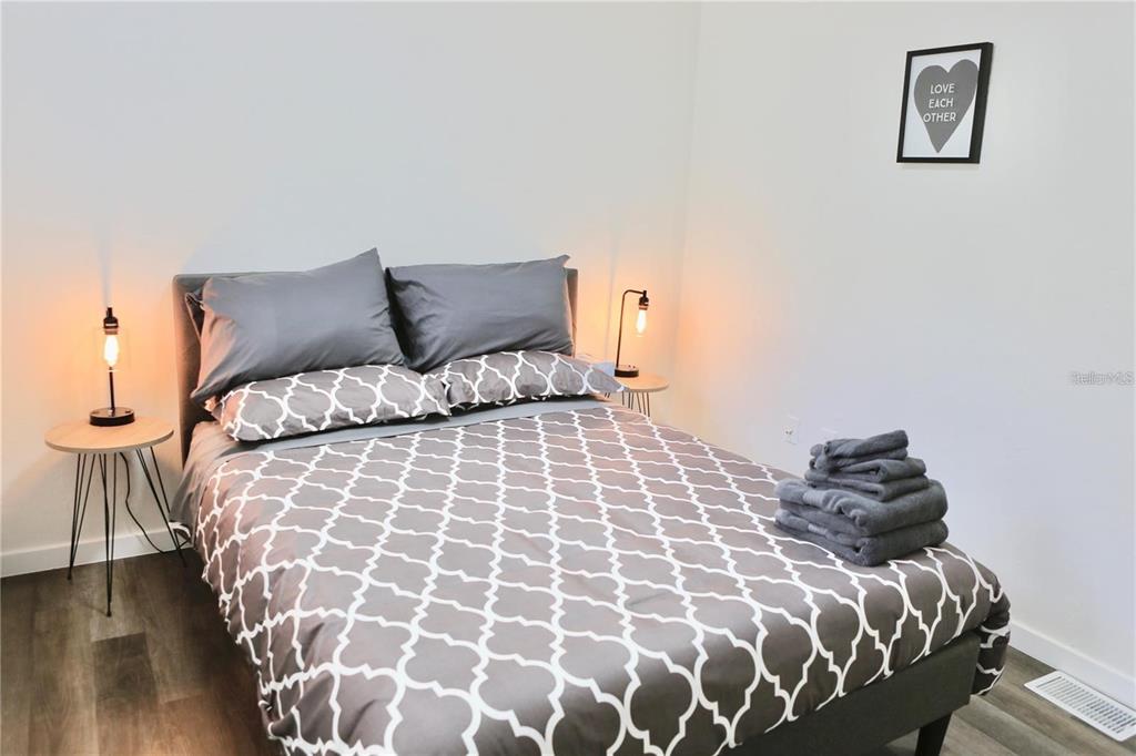 3308 Southwest 26 Way, Unit B Gainesville, FL 32608 - Photo 14 of 23 a bedroom with a bed and a painting on the wall