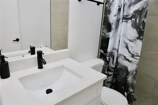 a bathroom with a sink a toilet and a tub