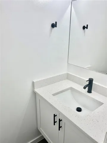a bathroom with a sink and mirror