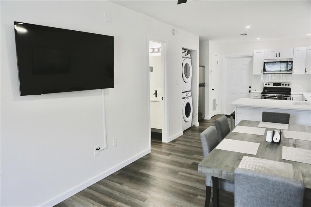 3308 Southwest 26 Way, Unit B Gainesville, FL 32608 - Photo 3 of 23 a living room with furniture a flat screen tv and a fireplace