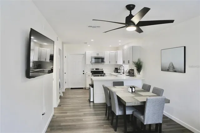 a view of kitchen with cabinets table and chairs