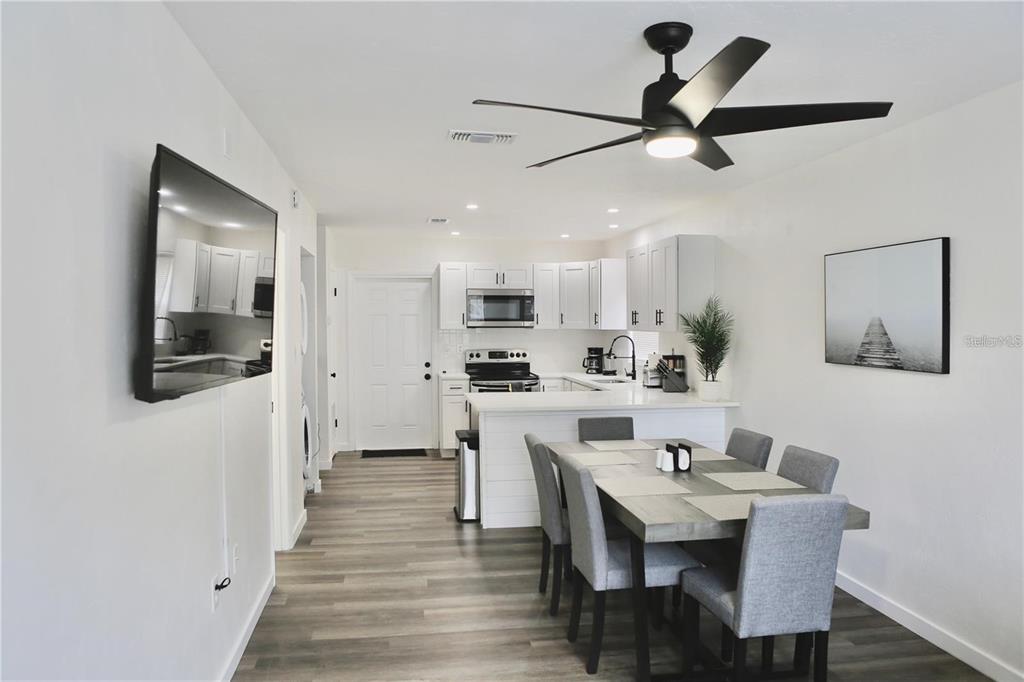 3308 Southwest 26 Way, Unit B Gainesville, FL 32608 - Photo 4 of 23 a view of kitchen with cabinets table and chairs