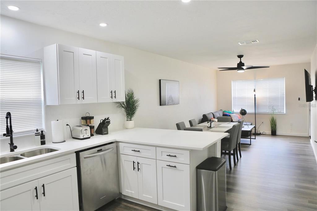3308 Southwest 26 Way, Unit B Gainesville, FL 32608 - Photo 6 of 23 a kitchen with a sink cabinets and wooden floor
