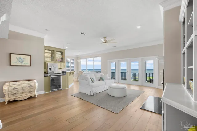 a living room with furniture a chandelier and a flat screen tv