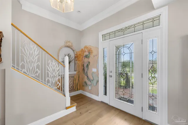 a view of a dining room with furniture wooden floor and chandelier