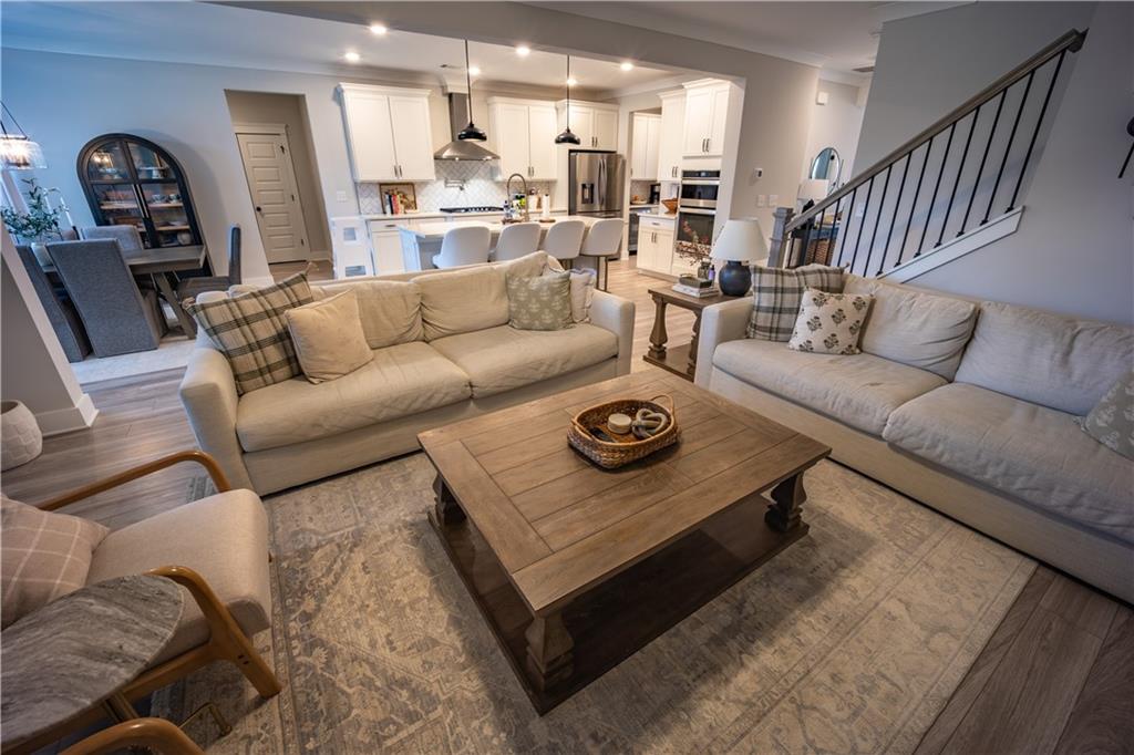 6833 Benjamin Drive Flowery Branch, GA 30542 - Photo 14 of 30 a living room with furniture and a wooden floor