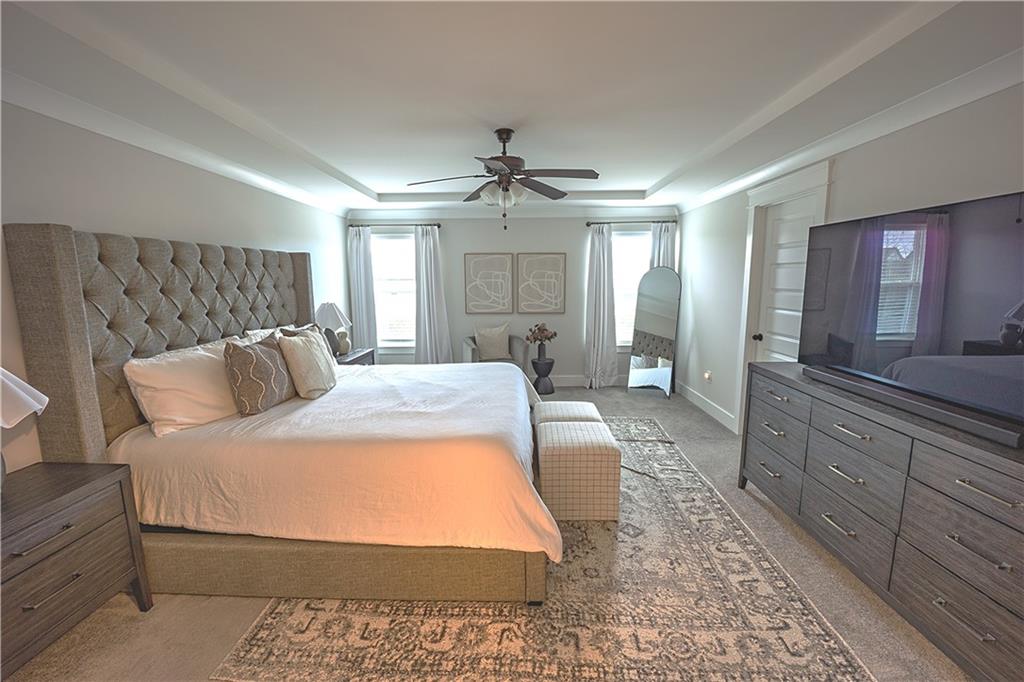 6833 Benjamin Drive Flowery Branch, GA 30542 - Photo 15 of 30 a bed room with a bed and a chandelier