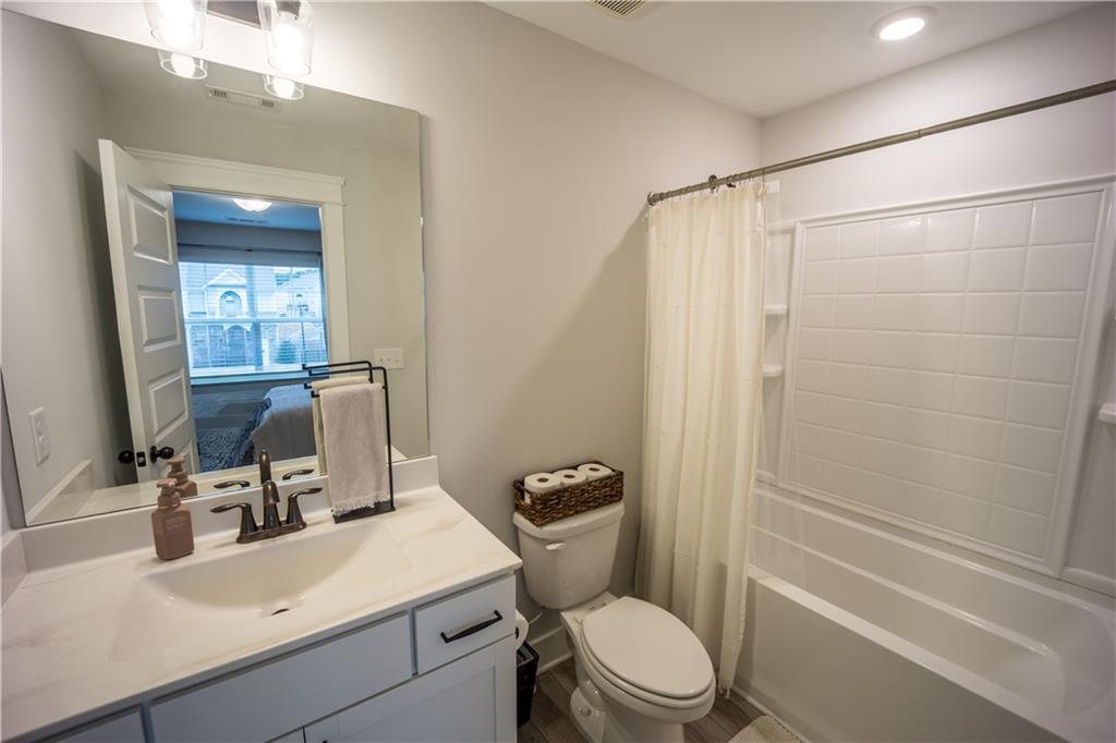 6833 Benjamin Drive Flowery Branch, GA 30542 - Photo 19 of 30 a bathroom with a sink toilet vanity and shower