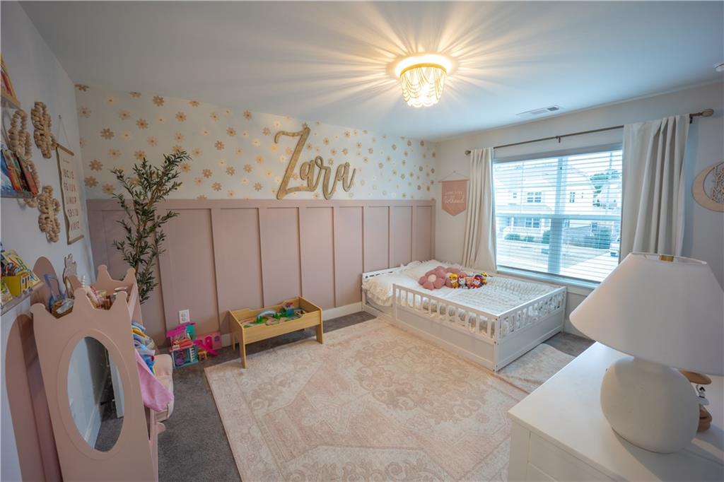 6833 Benjamin Drive Flowery Branch, GA 30542 - Photo 20 of 30 a bedroom with furniture and a bed