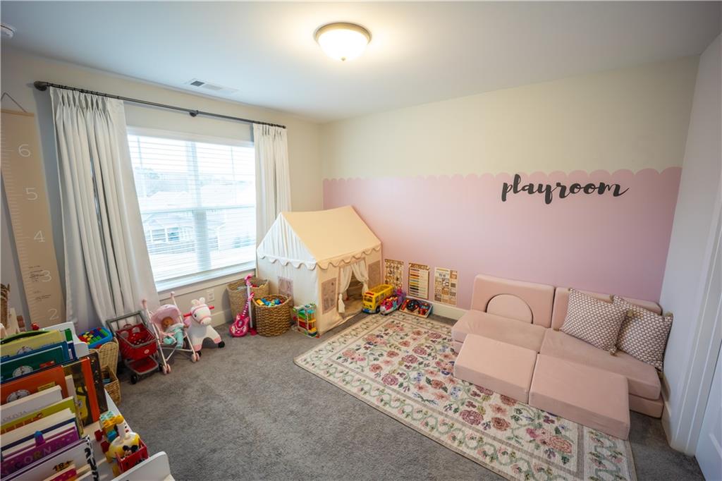 6833 Benjamin Drive Flowery Branch, GA 30542 - Photo 21 of 30 a living room with furniture and a window