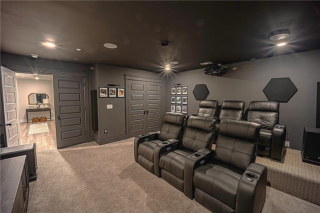 6833 Benjamin Drive Flowery Branch, GA 30542 - Photo 25 of 30 a media room with lots of chairs and mirrors