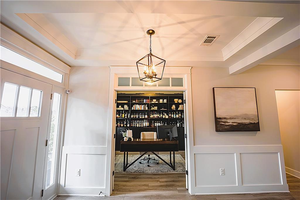 6833 Benjamin Drive Flowery Branch, GA 30542 - Photo 3 of 30 a view of a hallway with wooden floor and windows