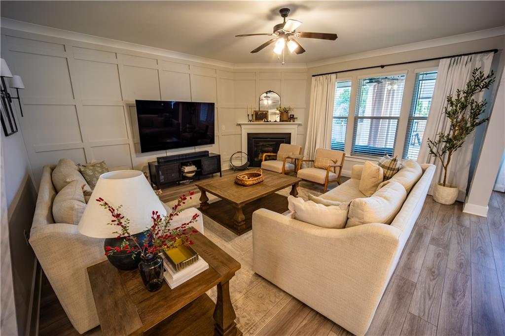 6833 Benjamin Drive Flowery Branch, GA 30542 - Photo 6 of 30 a living room with furniture a flat screen tv and a fireplace