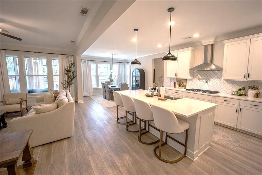 6833 Benjamin Drive Flowery Branch, GA 30542 - Photo 7 of 30 a large kitchen with a table and chairs