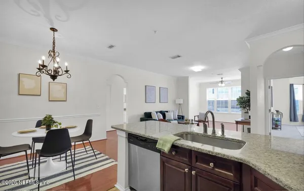 a view of living room kitchen island dining table and chairs