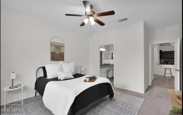 a bedroom with a bed and a chandelier