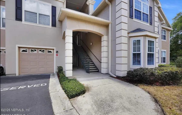 a view of a brick house with a yard