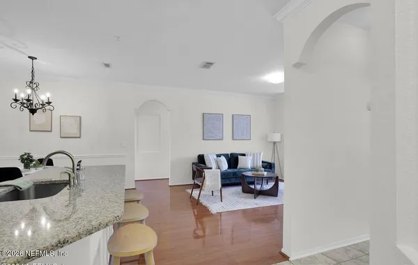 a living room with furniture and a mirror