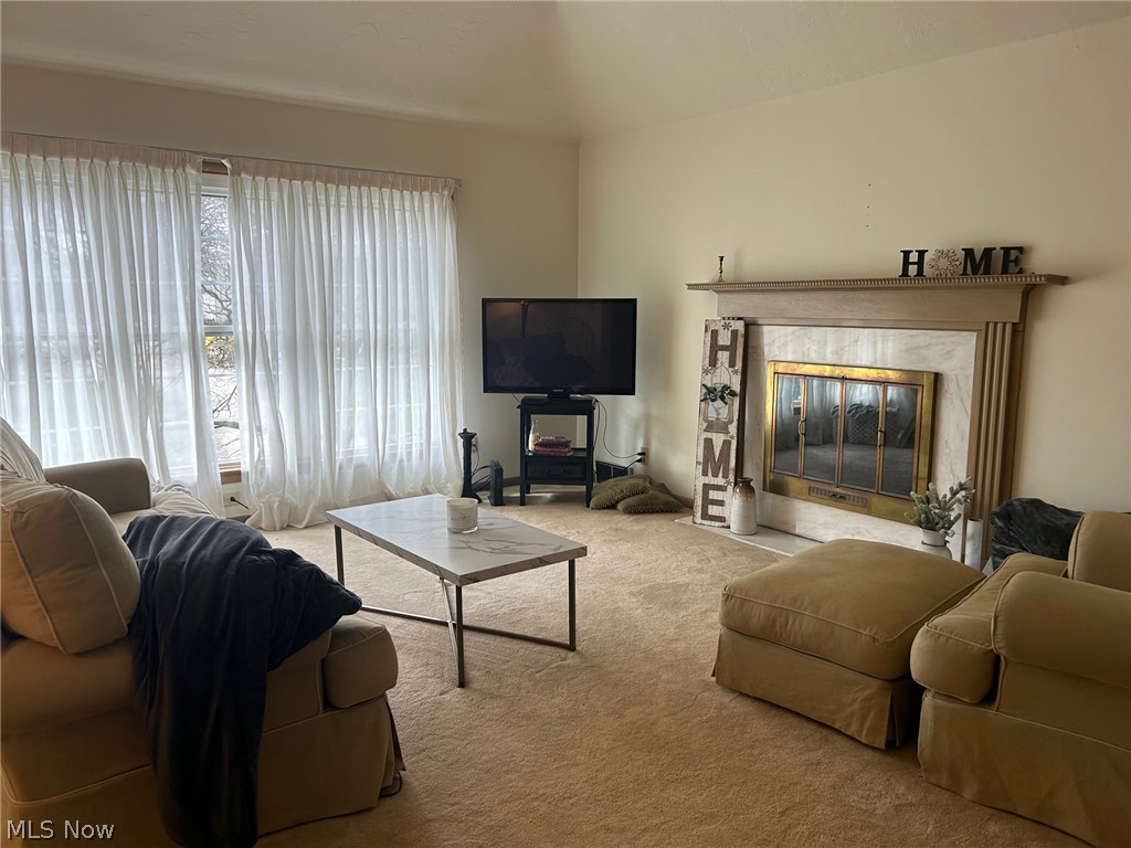 2537 Falmouth Road Akron, OH 44333 - Photo 3 of 35 Living room with light carpet and a high end fireplace