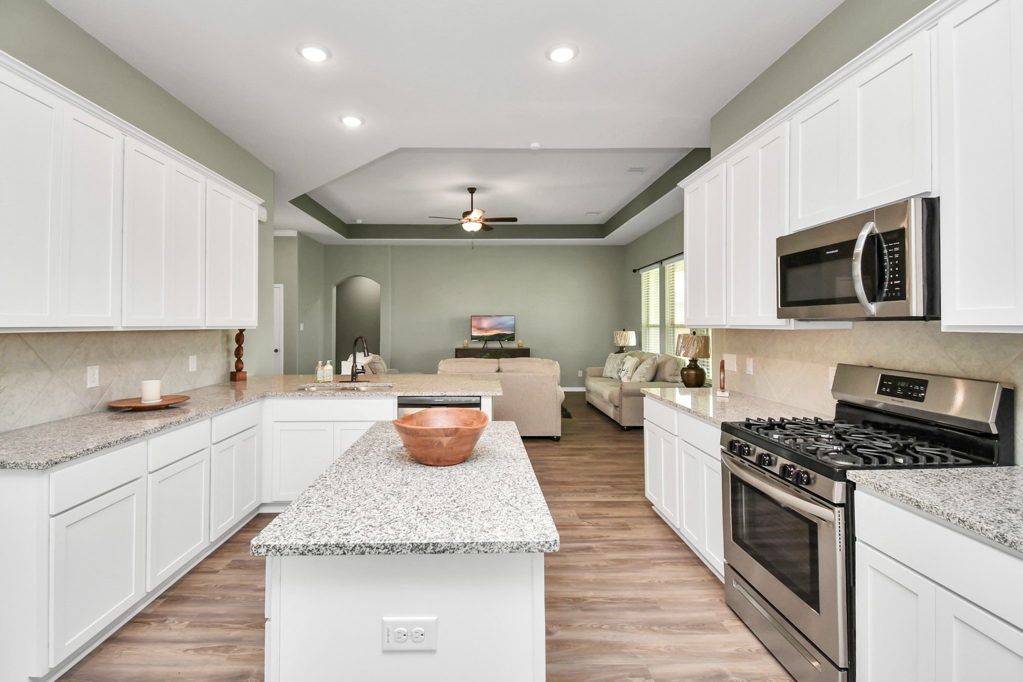 395 Hunter Ranch Way Dayton, TX 77535 - Photo 17 of 42 a kitchen with sink a microwave and cabinets