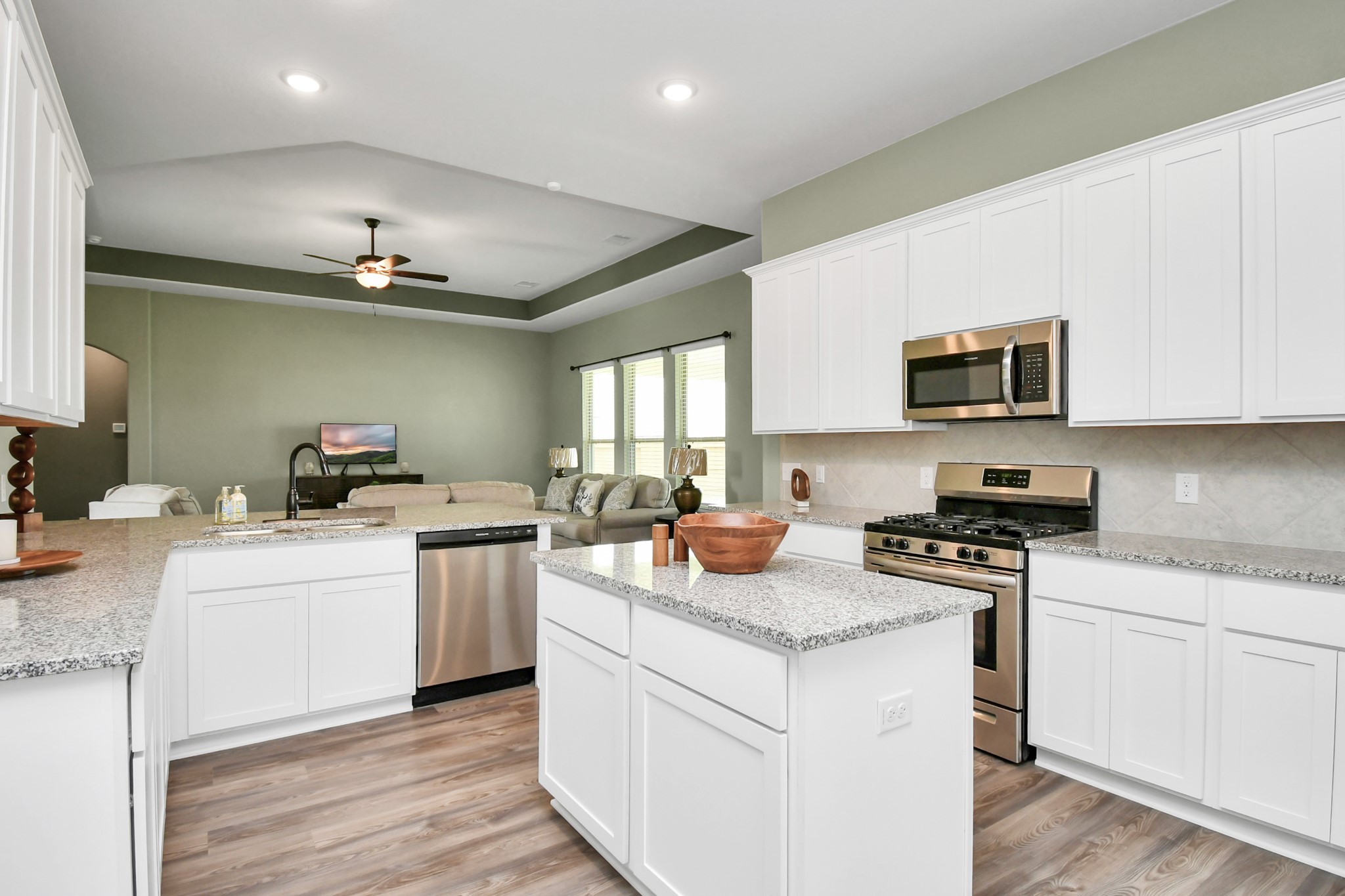395 Hunter Ranch Way Dayton, TX 77535 - Photo 18 of 42 a kitchen with a stove cabinets and wooden floor