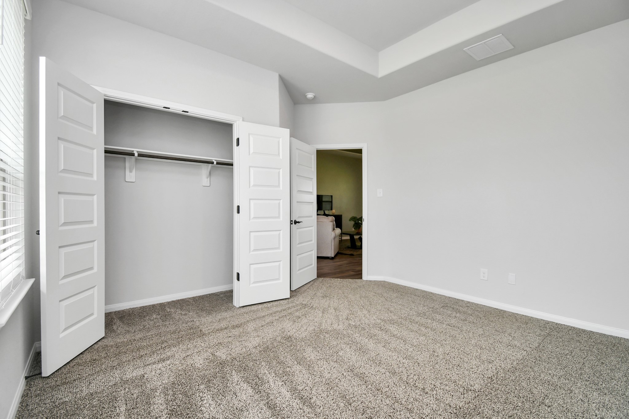 395 Hunter Ranch Way Dayton, TX 77535 - Photo 23 of 42 an empty room with closet and natural light