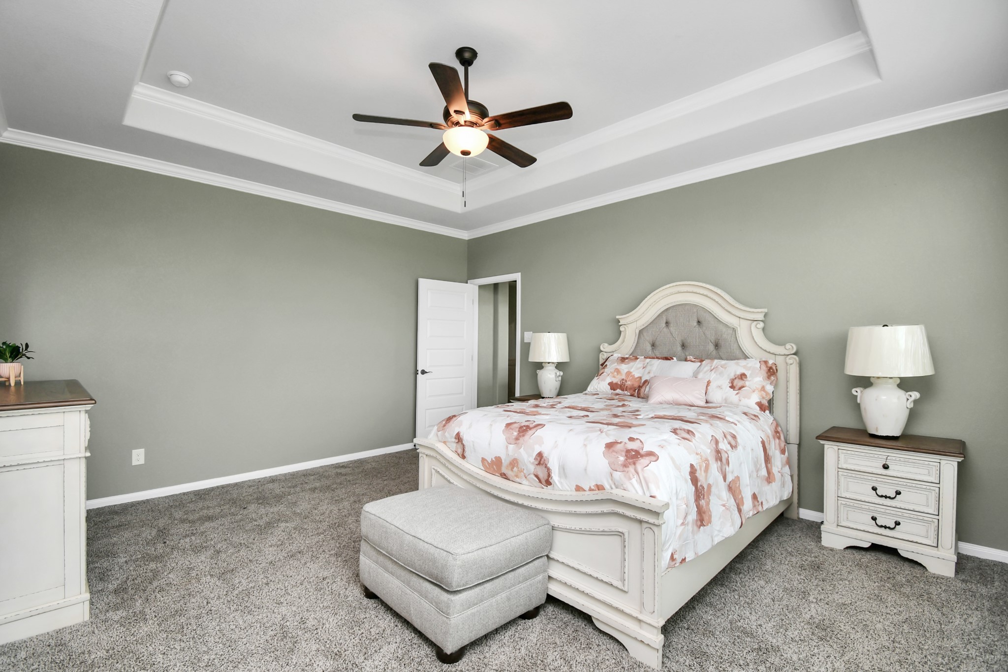 395 Hunter Ranch Way Dayton, TX 77535 - Photo 33 of 42 a bedroom with a bed and a chandelier