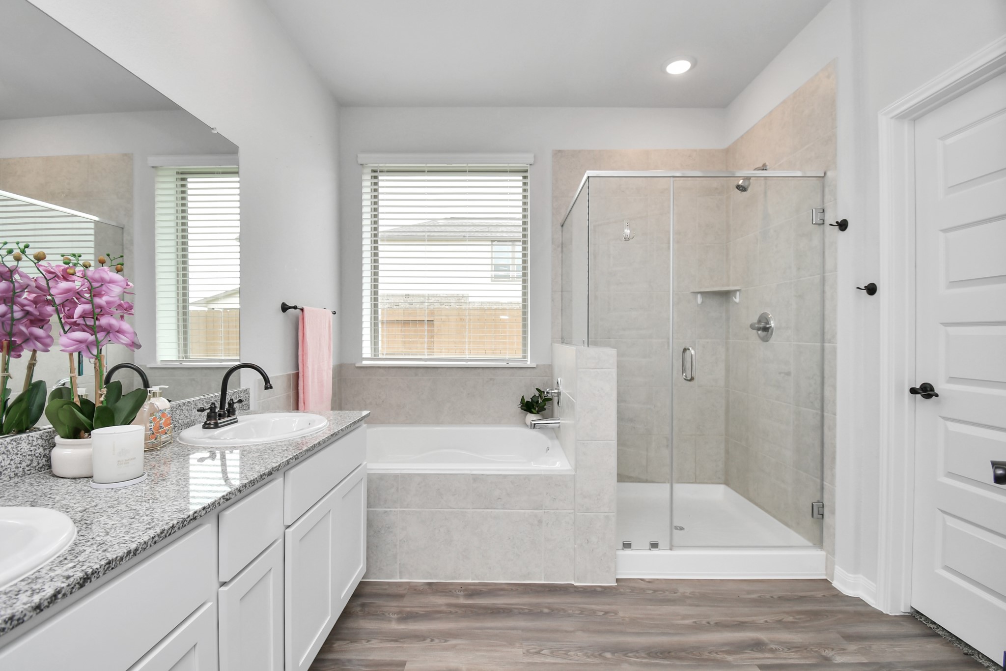 395 Hunter Ranch Way Dayton, TX 77535 - Photo 36 of 42 a bathroom with a granite countertop tub sink and mirror