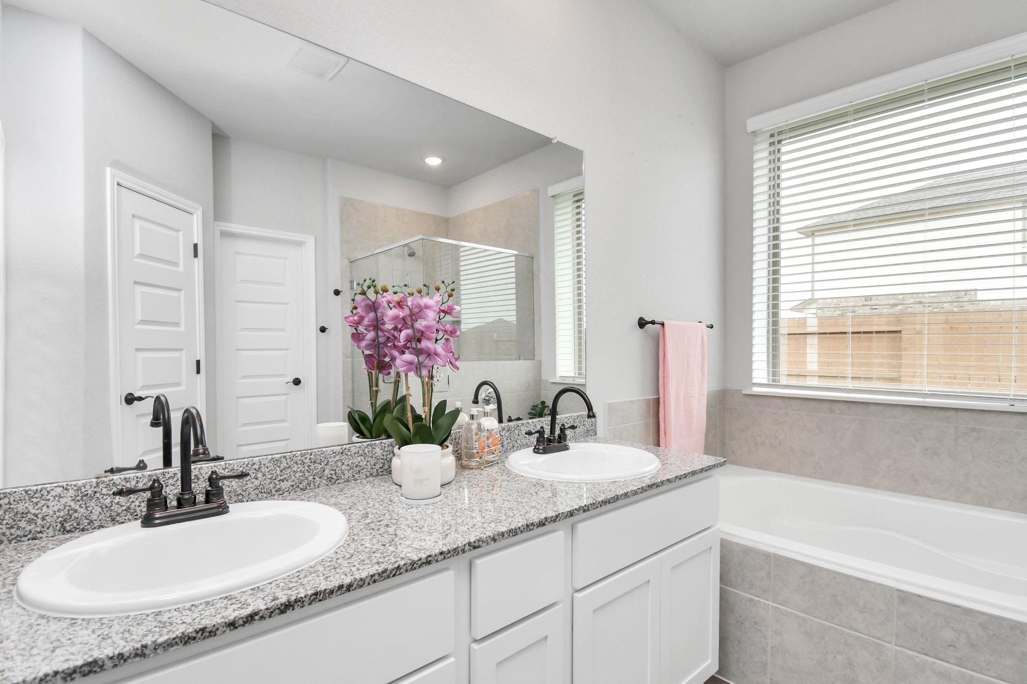 395 Hunter Ranch Way Dayton, TX 77535 - Photo 37 of 42 a bathroom with a granite countertop sink and a mirror