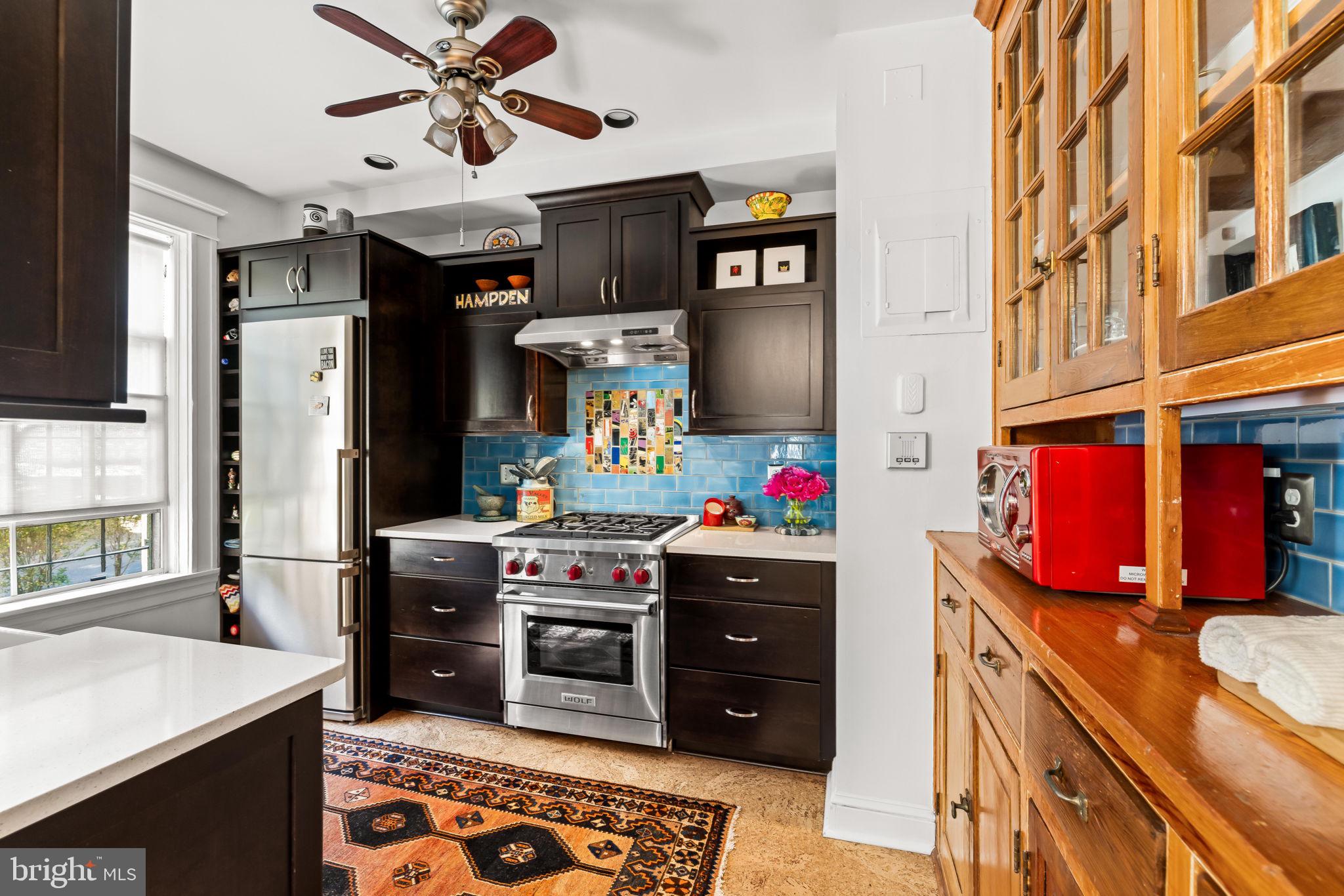 4300 Roland Avenue, Unit 101 Baltimore, MD 21210 - Photo 16 of 41 a kitchen with stainless steel appliances granite countertop a sink stove and refrigerator