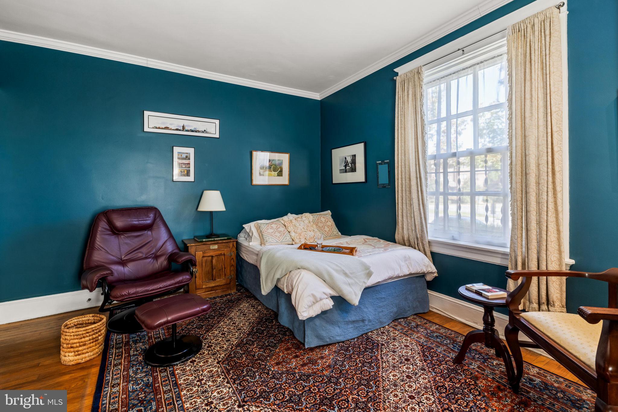 4300 Roland Avenue, Unit 101 Baltimore, MD 21210 - Photo 24 of 41 a bedroom with a bed and wooden floor