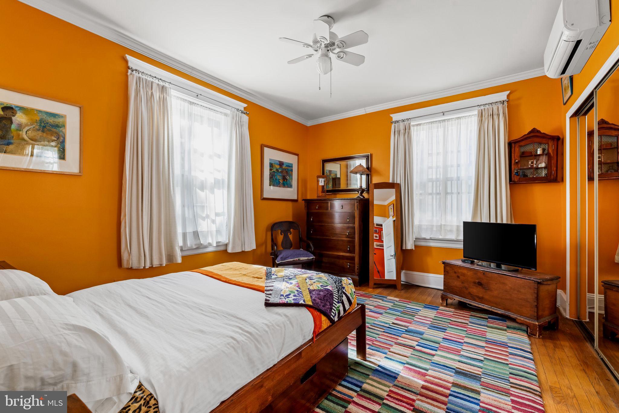 4300 Roland Avenue, Unit 101 Baltimore, MD 21210 - Photo 29 of 41 a bedroom with a bed and a flat screen tv
