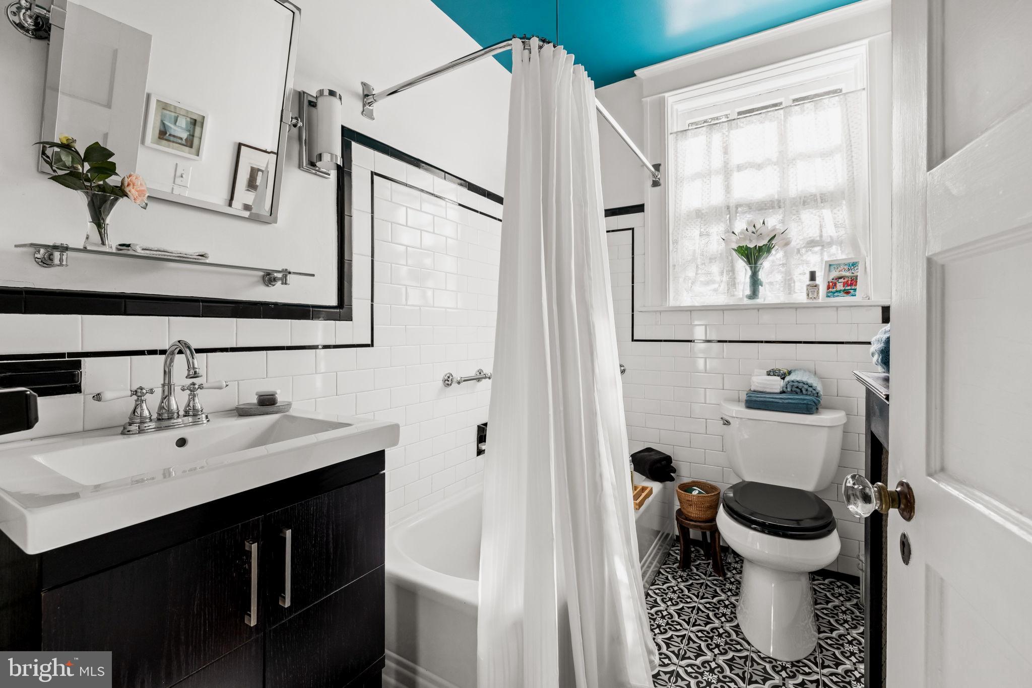 4300 Roland Avenue, Unit 101 Baltimore, MD 21210 - Photo 30 of 41 a bathroom with a sink a toilet and a mirror