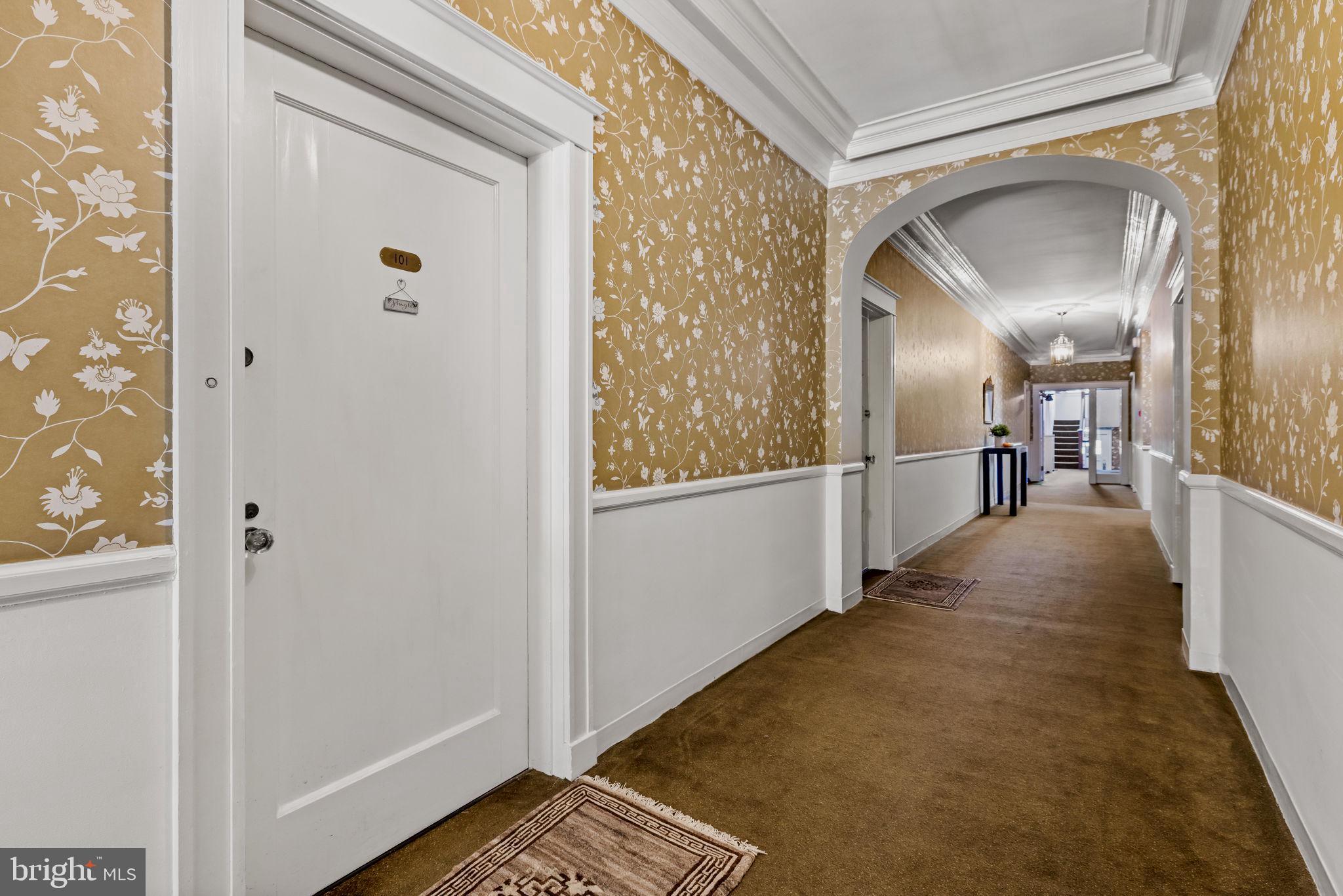 4300 Roland Avenue, Unit 101 Baltimore, MD 21210 - Photo 33 of 41 a view of a hallway with wooden floor and staircase