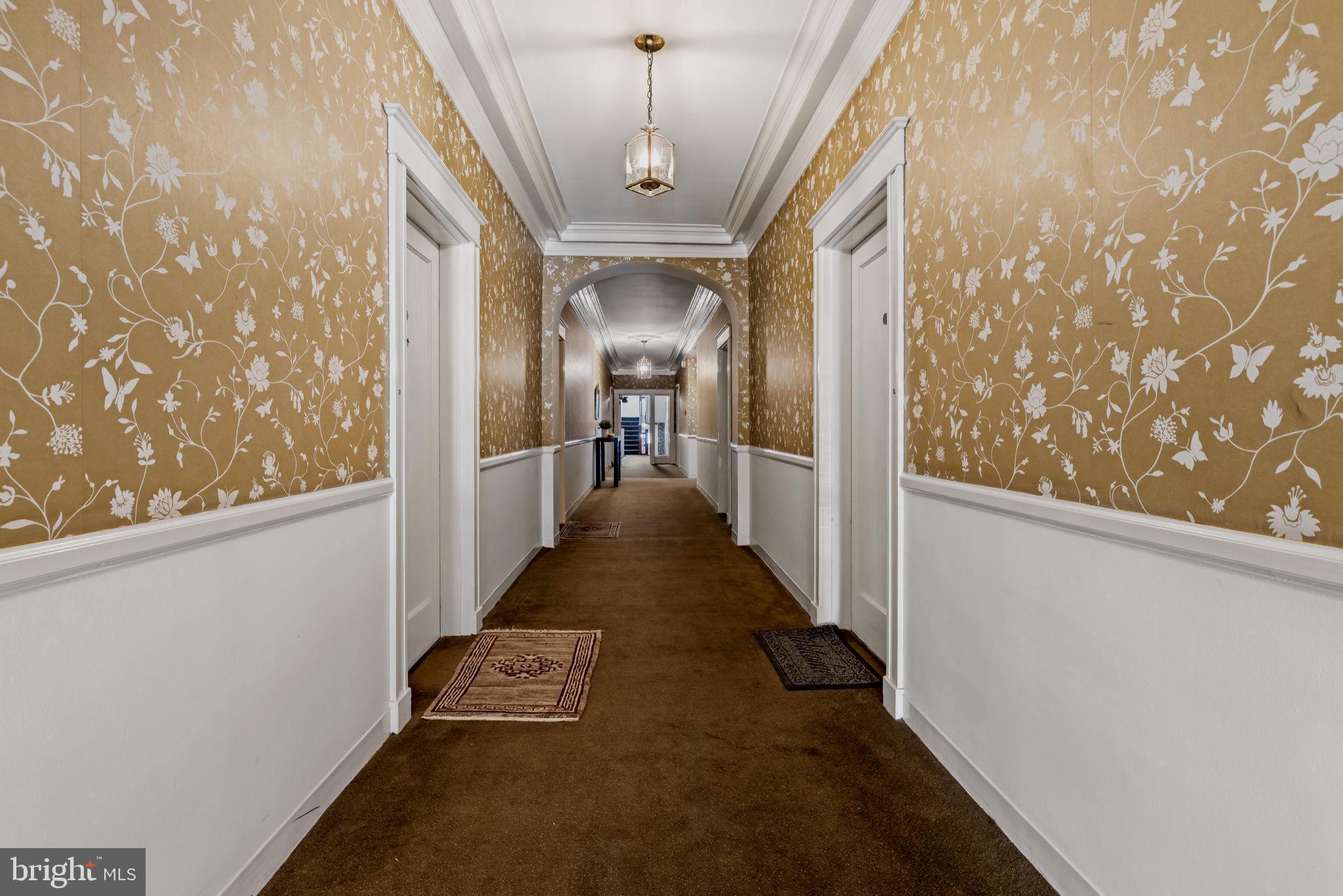 4300 Roland Avenue, Unit 101 Baltimore, MD 21210 - Photo 34 of 41 a view of a hallway with wooden floor and door