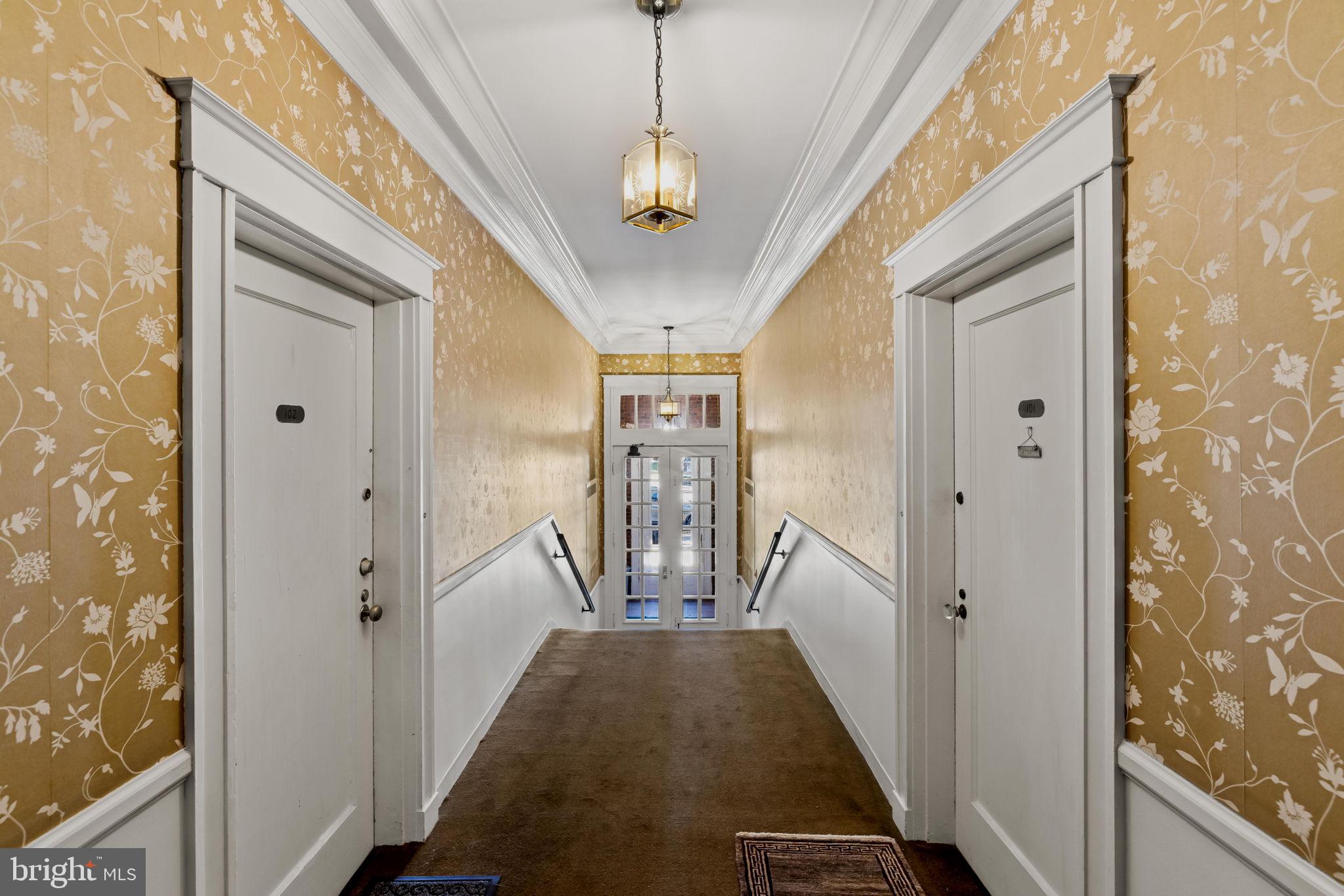 4300 Roland Avenue, Unit 101 Baltimore, MD 21210 - Photo 35 of 41 a view of a hallway with windows and stairs