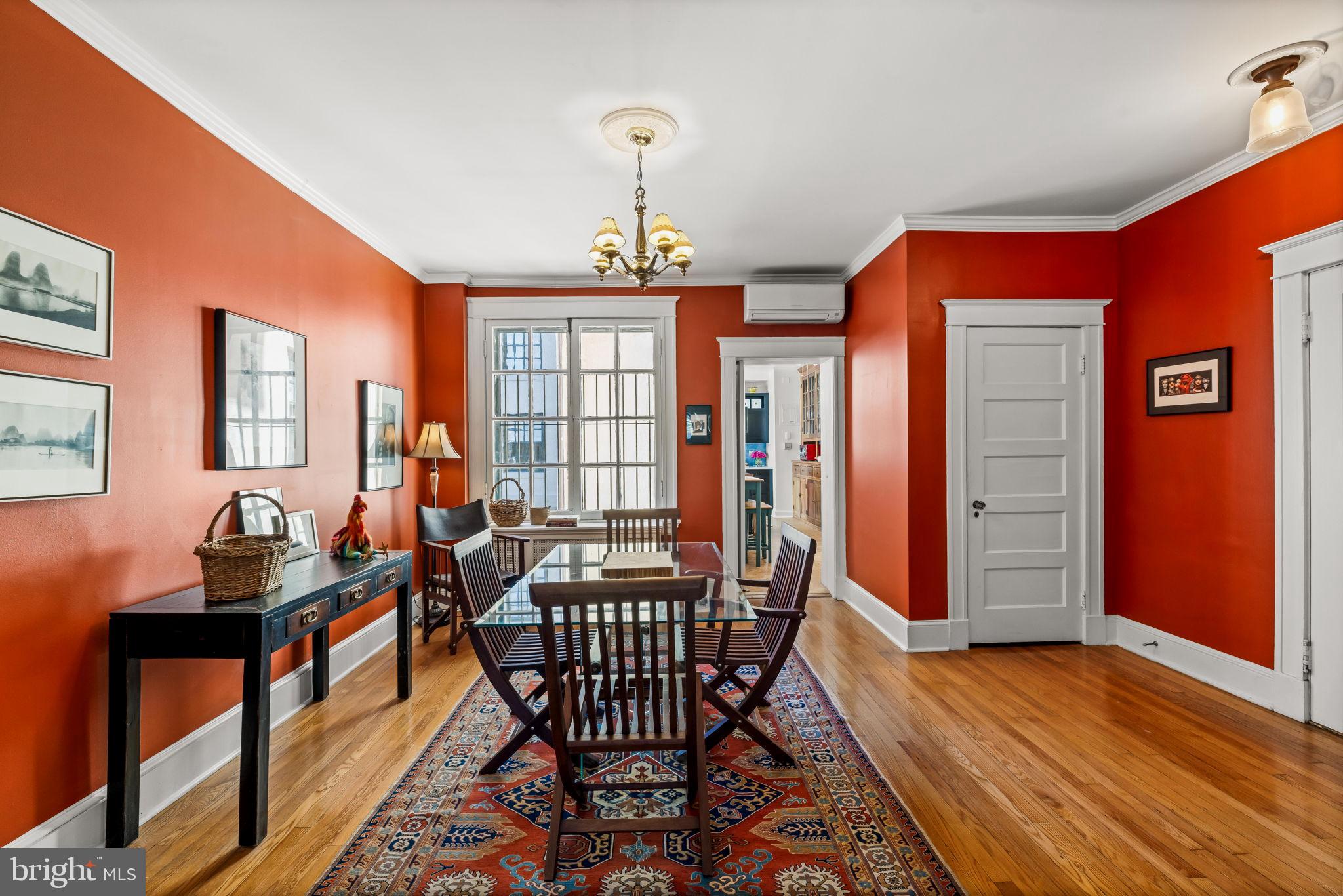 4300 Roland Avenue, Unit 101 Baltimore, MD 21210 - Photo 9 of 41 a dining room with furniture a chandelier and wooden floor