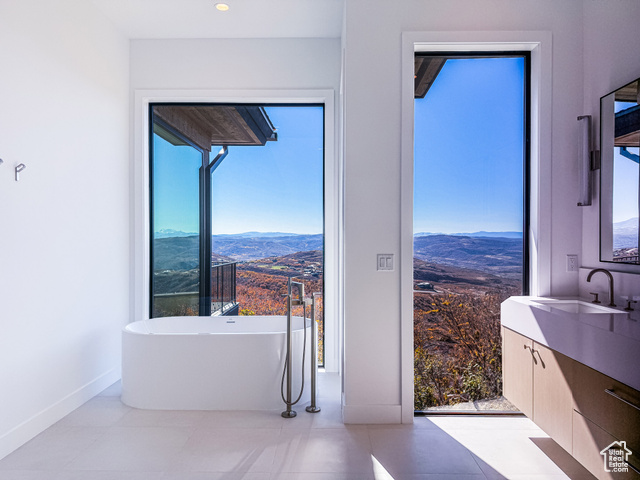 2132 East Outlaw Road, Unit 49 Kamas, UT 84036 - Photo 17 of 44 Bathroom with a mountain view, a soaking tub, vanity, and light tile patterned floors