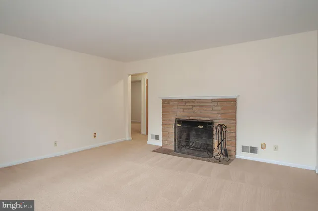 an empty room with a fireplace