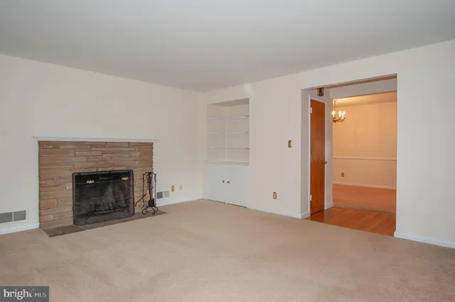 an empty room with a fireplace