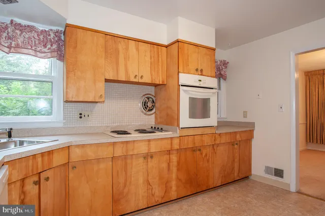 a kitchen with stainless steel appliances a sink and cabinets