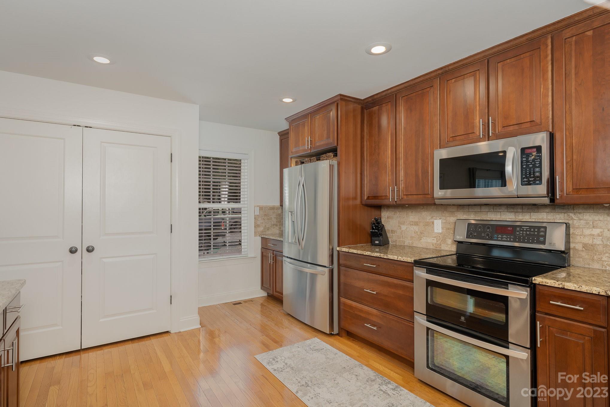 5816 Sharon Road Charlotte, NC 28210 - Photo 11 of 33 a kitchen with stainless steel appliances granite countertop a refrigerator and a stove top oven