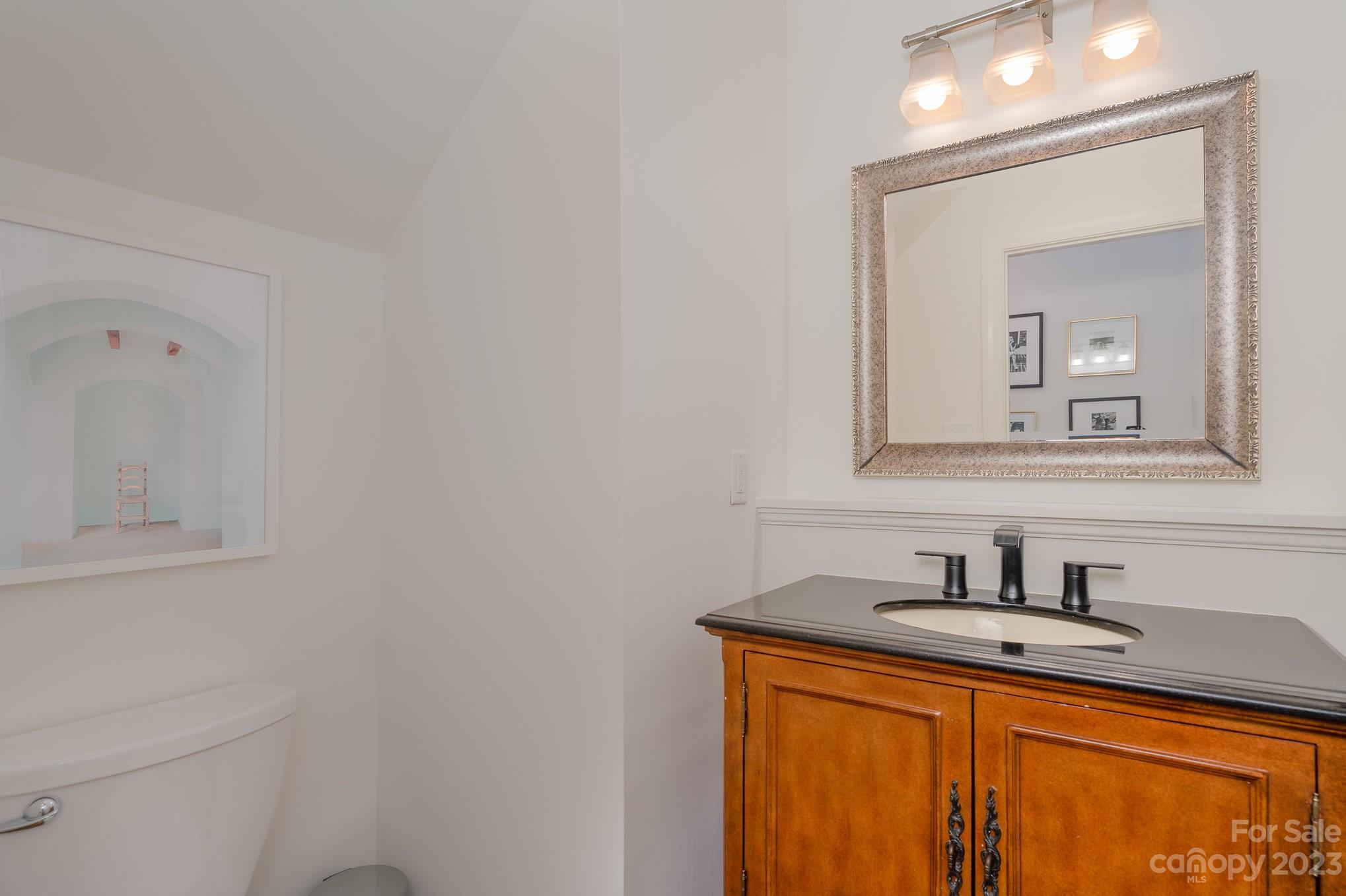 5816 Sharon Road Charlotte, NC 28210 - Photo 16 of 33 a bathroom with a sink and a mirror
