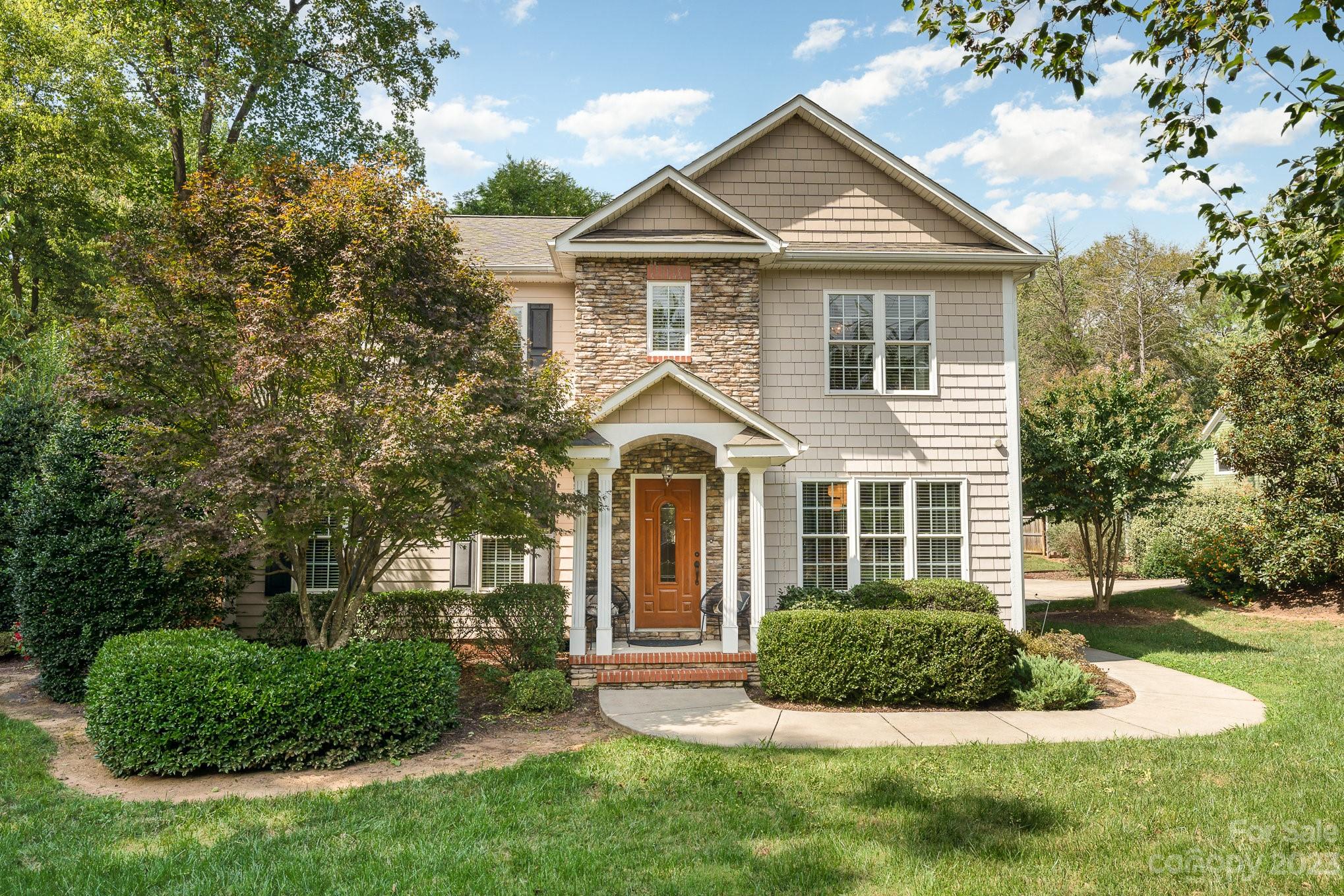 5816 Sharon Road Charlotte, NC 28210 - Photo 2 of 33 a front view of a house with a yard and garage