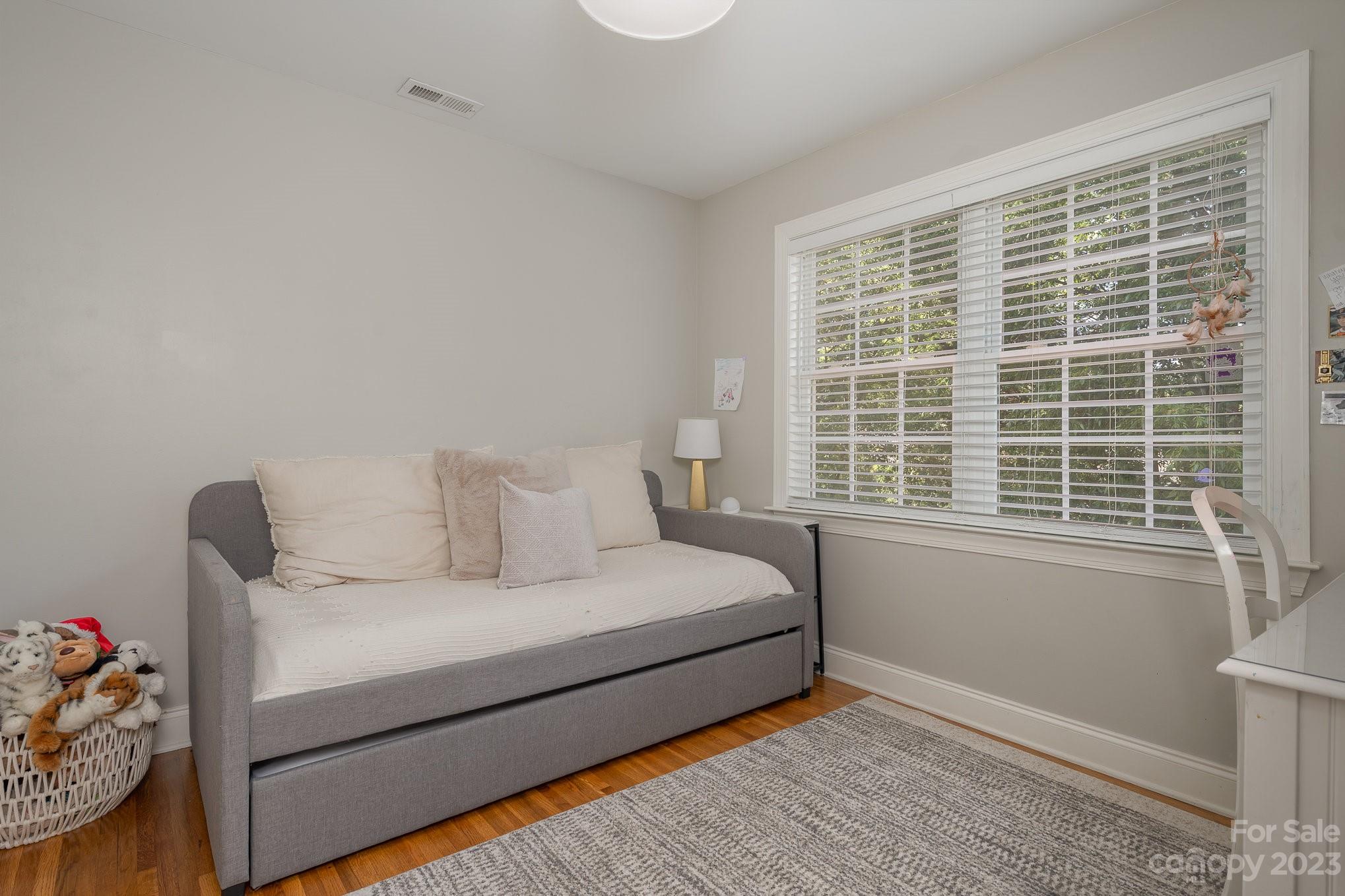 5816 Sharon Road Charlotte, NC 28210 - Photo 24 of 33 a bedroom with a bed and wooden floor