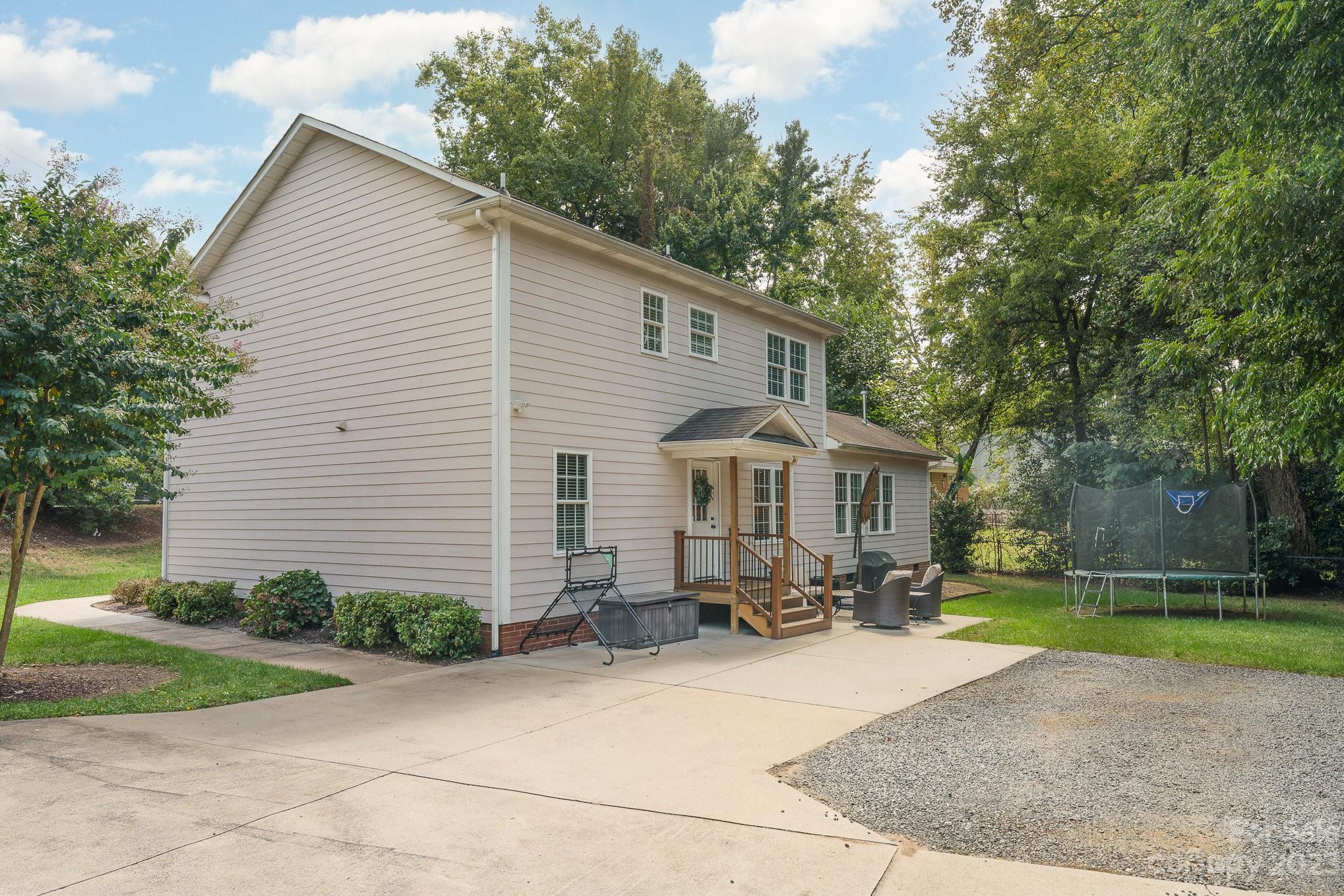 5816 Sharon Road Charlotte, NC 28210 - Photo 25 of 33 a view of a house with yard and a garden